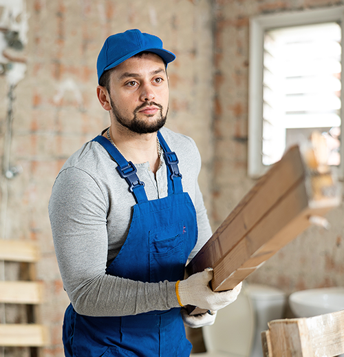 Worker holding wooden planks